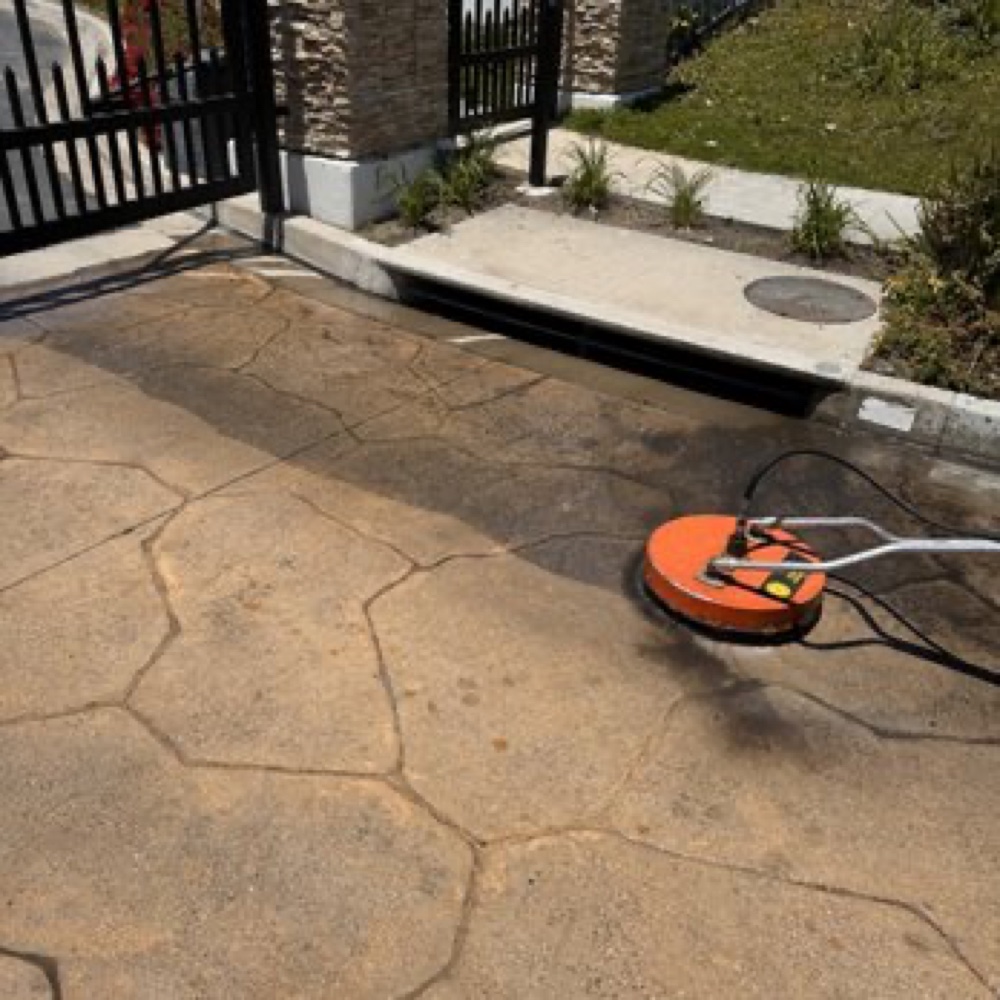 Pressure washing progress on a paved surface for pressure washing in Carlsbad