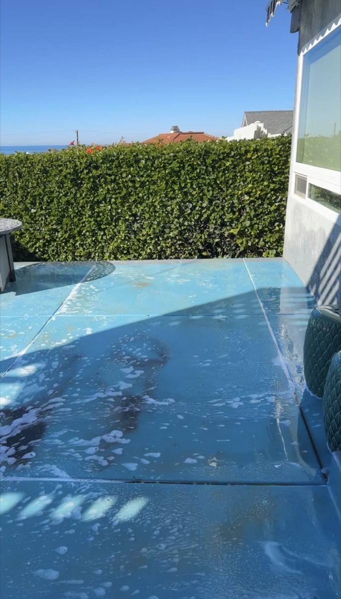 Patio surface being cleaned for pressure washing in Carlsbad