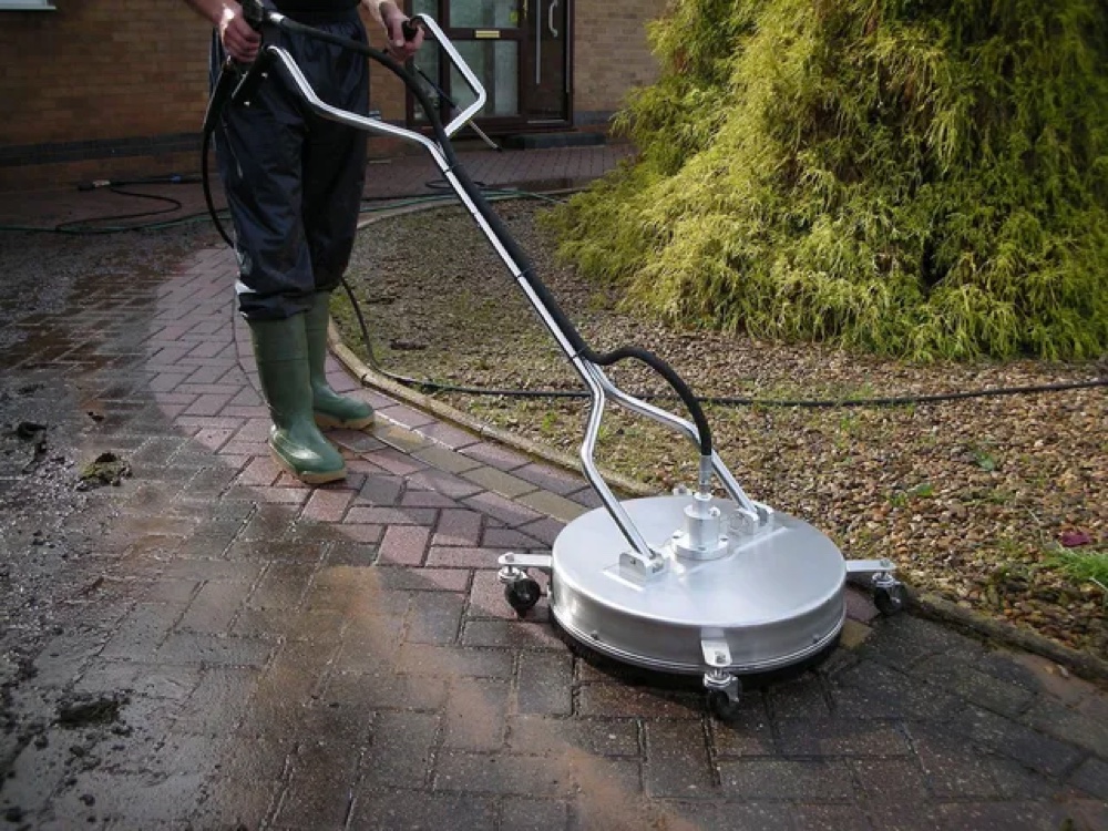 Exterior surface cleaner in use on a walkway